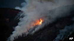 Flames from the Ferguson Fire burn down a hillside in unincorporated Mariposa County Calif., near Yosemite National Park, July 15, 2018.