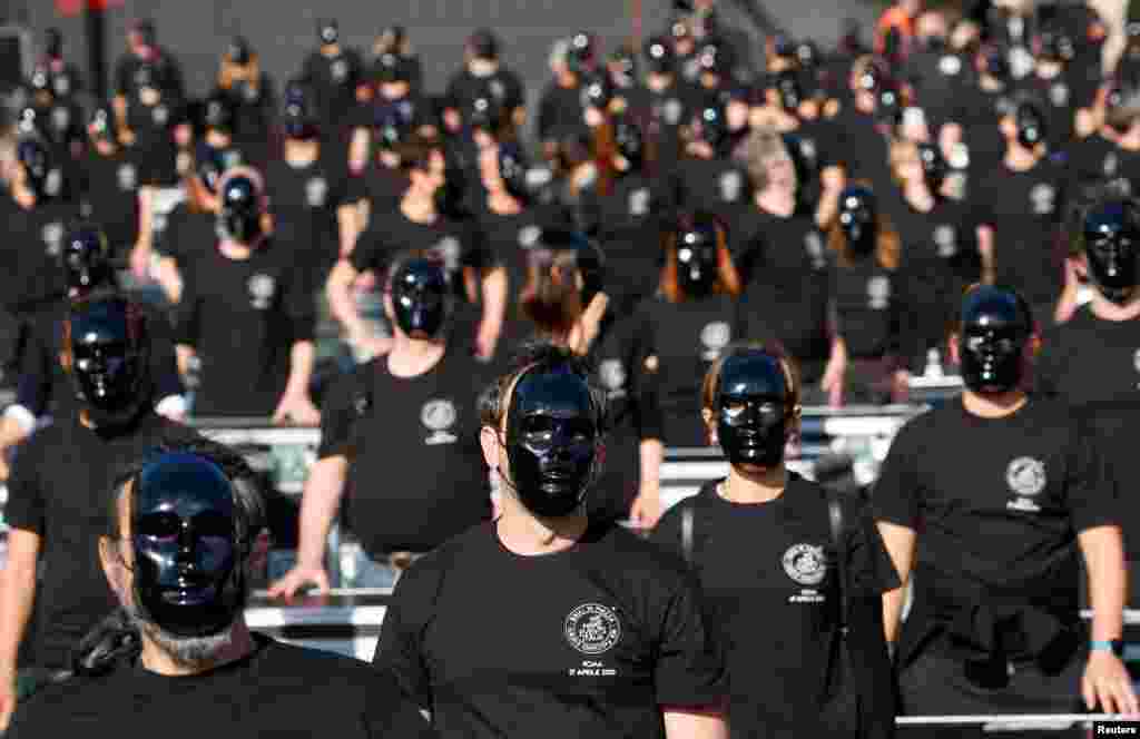 Theater workers wearing masks attend a demonstration calling on the government to let artists return to work amid the COVID-19 outbreak, at Piazza del Popolo in Rome, Italy, April 17, 2021.