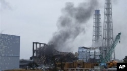 Smoke rising from Unit 3 of the tsunami-stricken Fukushima Dai-ichi nuclear power plant, Okumamachi, Japan, March 21, 2011.