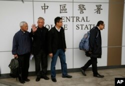 Four protest leaders, from right, Benny Tai Yiu-ting, Chan Kin-man, Chu Yiu-ming and former Cardinal Joseph Zen, walk inside the police station in Hong Kong as they surrender to police, Dec. 3, 2014.