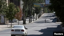 A man crosses the main street of the eastern Ukrainian city of Donetsk, July 27, 2014. 