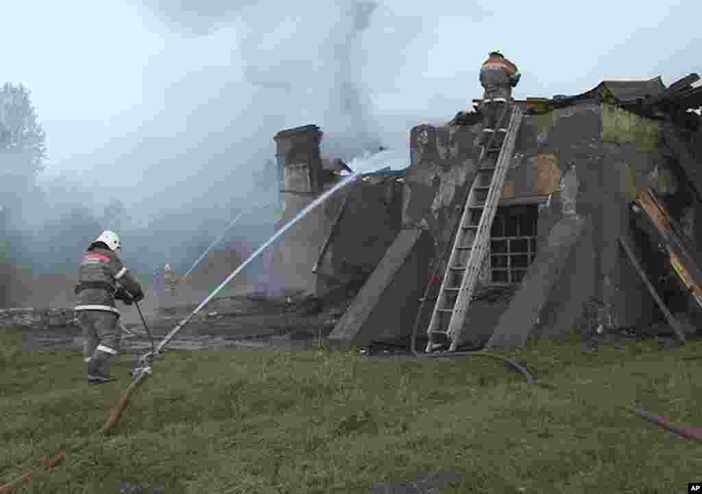 Emergency Situations workers and fire fighters work at a site of a fire at a psychiatric hospital in Luka village in the Novgorod region, Russia, Sept. 13, 2013. (Russian Emergency Ministry)