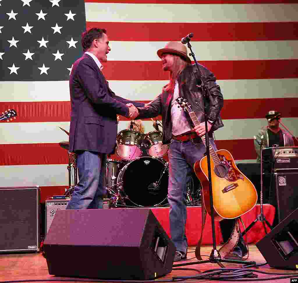 Republican presidential candidate Mitt Romney shakes hands with musician Kid Rock after he performed a song at a campaign rally in Royal Oak, Michigan on February 27, 2012. (AP)