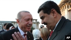 FILE - Turkey's President Recep Tayyip Erdogan (L) talks to Venezuela's President Nicolas Maduro (R) prior to a dinner following a ceremony at the Presidential Palace in Ankara, Turkey, July 9, 2018.