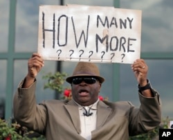 Rev. Arthur Prioleau holds a sign during a protest in the shooting death of Walter Scott at city hall in North Charleston, April 8, 2015.