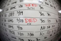 This May 13, 2020, photo taken with a fisheye lens shows a list of the confirmed COVID-19 cases in Salt Lake County early in the coronavirus pandemic at the Salt Lake County Health Department, in Salt Lake City. (AP Photo/Rick Bowmer)