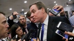 Senate Intelligence Committee Vice Chairman Sen. Mark Warner, D-Va., whose panel is investigating Russian interference in the 2016 election, speaks with reporters in Washington, June 22, 2017.