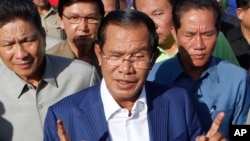 FILE - In this Aug. 1, 2018, file photo, Cambodian Prime Minister Hun Sen gestures while speaking in Phnom Penh, Cambodia. Cambodian Prime Minister Hun Sen, at the polling place near his home on the day of the general election on July 29, 2018. The official results, being announced province-by-province and party-by-party Wednesday, Aug. 15, 2018, were certain to confirm a landslide victory by Hun Sen's Cambodian People's Party, but critics called the election unfair because the only credible opposition force, the Cambodia National Rescue Party, could not contest the polls because it was dissolved by court order last year. (AP Photo/Heng Sinith)