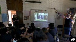 Estudiantes de la escuela Amaranta Gómez, creada por la Fundación Selena, que acoge a menores y adolescentes transgénero, observan al presidente Sebastián Piñera mientras habla de la nueva Ley de Identidad de Género.