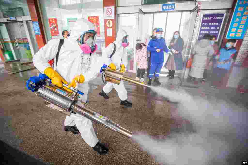 Workers disinfecting a bus station in Bijie, in China&#39;s southwest Guizhou province, as authorities prepare for a travel peak ahead of the Lunar New Year, which ushers in the Year of the Ox.