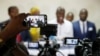 Journalists use their mobile phones and cameras at a candidate's pre-election news conference in Kinshasa, Democratic Republic of Congo, Dec. 25, 2018.