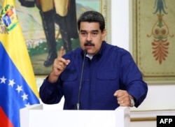 Handout picture released by the Venezuelan presidency showing Venezuelan President Nicolas Maduro speaking during a press conference at the Miraflores Presidential Palace in Caracas, Venezuela, March 11, 2019.