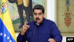 Handout picture released by the Venezuelan presidency showing Venezuelan President Nicolas Maduro speaking during a press conference at the Miraflores Presidential Palace in Caracas, Venezuela, March 11, 2019.