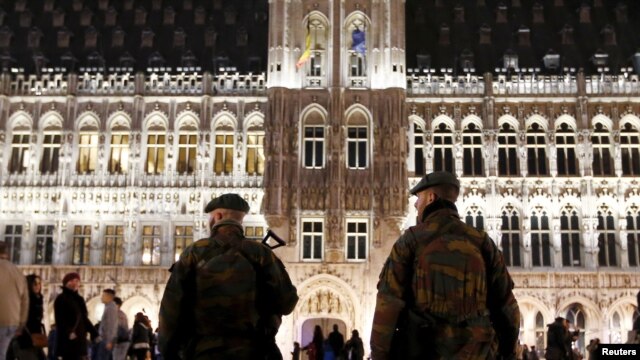 Soldados belgas patrullan un mercado navideño frente al Gran Palacio de Bruselas.