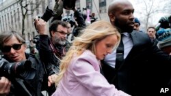 FILE -Stormy Daniels arrives at federal court in New York to attend a court hearing where a federal judge is considering how to review materials that the FBI seized from President Donald Trump's personal lawyer to determine whether they should be protected by attorney-client privilege, April 16, 2018.