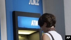 Customers are seen in front of ANZ Bank, Australian and New Zealand Banking Group Ltd., ATM machine. The four largest banks—Acleda, Canadia, ANZ Royal and Cambodia Public—account for 70 percent of deposits and loans.