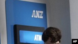 Customers are seen in front of ANZ Bank, Australian and New Zealand Banking Group Ltd., ATM machine. The four largest banks—Acleda, Canadia, ANZ Royal and Cambodia Public—account for 70 percent of deposits and loans.