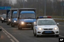 Trucks carry the bodies of the air crash victims from a city morgue to the crematorium for identification in St.Petersburg, Russia, Nov. 2, 2015.