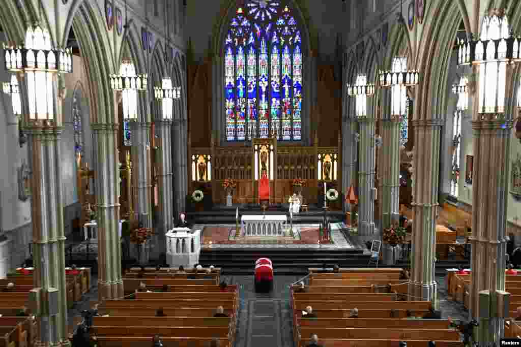 Mourners sit apart during the state funeral service for former Canadian prime minister John Turner at St. Michael&#39;s Cathedral Basilica in Toronto, Ontario.