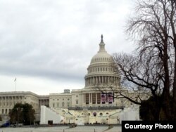 The U.S. Capitol looms over the stand for the inauguration of President-elect Donald Trump on the West Front of the Capitol in Washington, Sunday, Jan. 11, 2017. (D. Bekheet/VOA News)