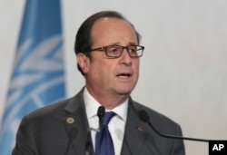FILE - France's President Francois Hollande speaks during the opening session of the U.N. climate conference in Marrakech, Morocco, Nov. 15, 2016.