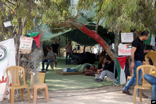 Para aktivis Palestina duduk di depan tenda untuk para pendukung masyarakat Bedouin Khan al-Ahmar di Tepi Barat, 21 Oktober 2018.