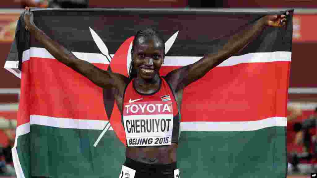 Kenya's Vivian Jepkemoi Cheruiyot celebrates after winning the gold medal in the women’s 10,000m final at the World Athletics Championships at the Bird's Nest stadium in Beijing, Monday, Aug. 24, 2015