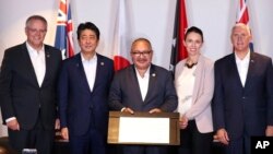 From left, prime ministers Scott Morrison of Australia, Shinzo Abe of Japan, Peter O'Neill of Papua New Guinea, Jacinda Ardern of New Zealand and U.S. Vice President Mike Pence pose after signing the Papua New Guinea Electrification Partnership, Nov. 18, 2018, in New Guinea.