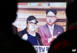 FILE - A TV screen shows pictures of North Korean leader Kim Jong Un and his older brother Kim Jong Nam, left, at the Seoul Railway Station in Seoul, South Korea, Feb. 14, 2017.