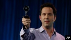 FILE - Maxime Veron, head of Hardware Product Marketing for Nest, holds up a Nest Cam during a press conference in San Francisco, June 17, 2015. 