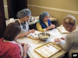 Even the youngest members of the kids' table can shape circles of homemade dough into traditional potato pierogies.