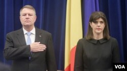 FILE - Romanian President Klaus Iohannis and Laura Codruta Kovesi, the chief of anti-corruption prosecutor, stand at the beginning of the anti-corruption agency's annual report, in Bucharest, Romania, Feb. 28, 2018.