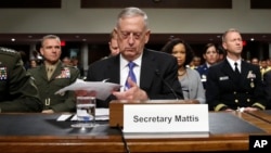 Defense Secretary Jim Mattis, center, prepares to testify on Capitol Hill in Washington, June 13, 2017, before a Senate Armed Services Committee hearing.