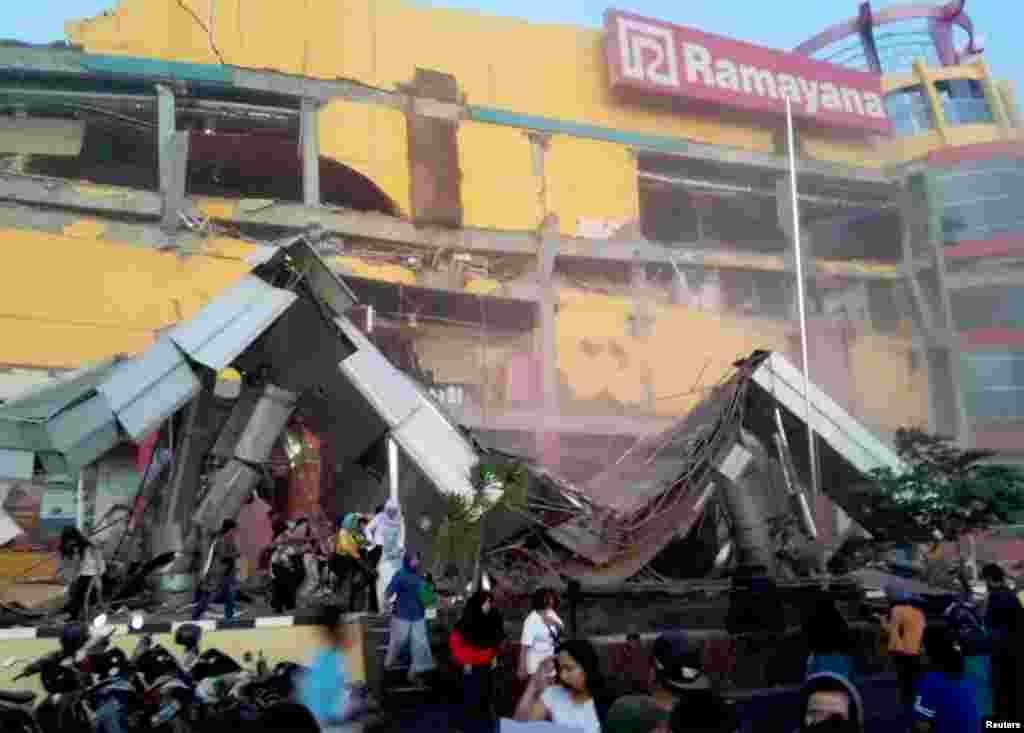 Heavy damage to a shopping center is seen following an earthquake in Palu, Central Sulawesi, Indonesia, Sept. 28, 2018, in this handout photo made available by Antara Foto.