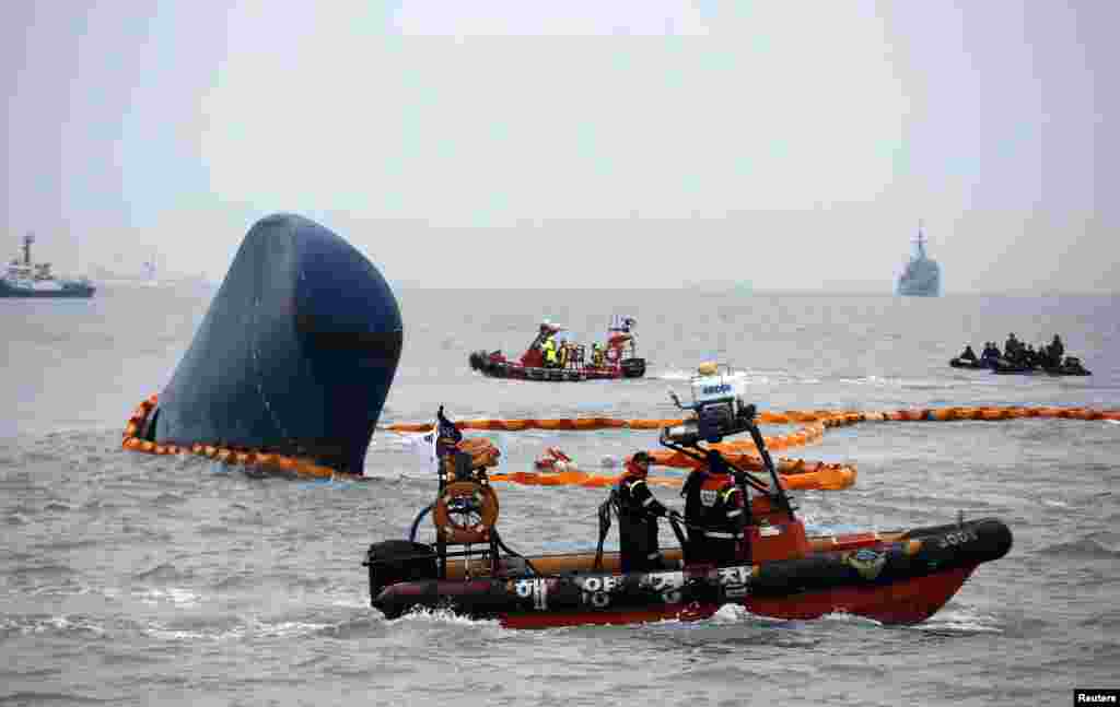 Rescue boats sail around the South Korean ferry "Sewol" which sank, during the rescue operation in the sea off Jindo. South Korean coastguard and navy divers resumed searching on Thursday for people still missing, many of them students from the same high school, after a ferry capsized in sight of land.