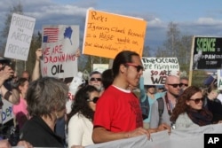 A few hundred people chanted slogans and made speeches to protest the presence of U.S. Secretary of State Rex Tillerson in Fairbanks, Alaska, May 10, 2017. High-level officials from the world's eight Arctic nations, including Tillerson, are meeting in Alaska amid concerns about the future of the sensitive region after President Trump called for more oil drilling and development.