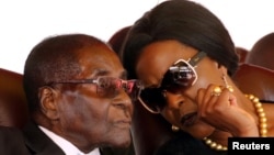 FILE: President Robert Mugabe and his wife Grace attend the burial of two independence luminaries, Maud Muzenda and George Rutanhire, in Harare, Zimbabwe August 26,2017. REUTERS/Philimon Bulawayo
