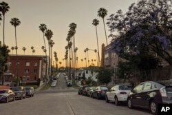 In this Thursday, May 21, 2020, photo vehicles are parked in Los Angeles. The coronavirus hasn't been kind to car owners. With more people than ever staying home to lessen the spread of COVID-19, their sedans, pickup trucks and SUVs are parked unattended on the streets, making them easy targets for opportunistic thieves. (AP Photo/Damian Dovarganes)