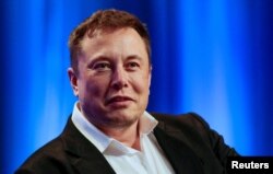 FILE - Tesla and SpaceX CEO Elon Musk participates in a "fireside chat" at the National League of Cities (NLC) 2018 City Summit in Los Angeles, California, Nov. 8, 2018.