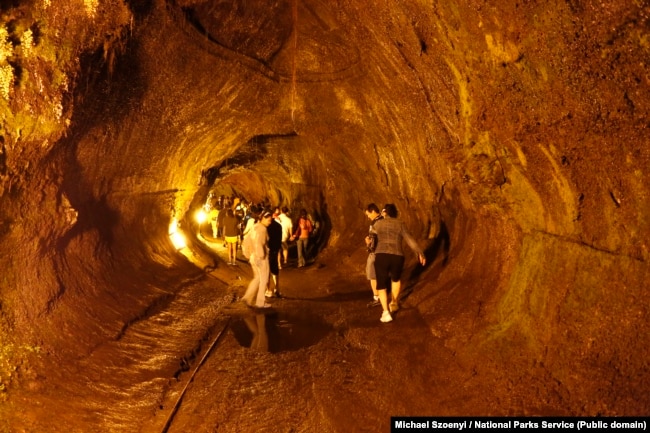 Visitors walk through the Thurston Lava Tube, or Nahuku in Hawaiian.