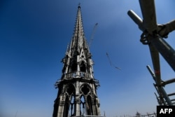 FILE - A picture take on April 11, 2019 shows the spire of Notre-Dame de Paris Cathedral during restauration works, in Paris.