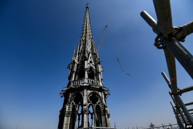 FILE - A picture take on April 11, 2019 shows the spire of Notre-Dame de Paris Cathedral during restauration works, in Paris.