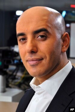 FILE - Notorious French gangster Redoine Faid poses for a photo prior to an interview with French TV channel, LCI, in Boulogne-Billancourt, outside Paris, France, Nov. 22, 2010.