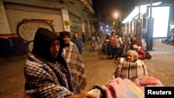 People gather on a street after an earthquake hit Mexico City, Mexico, Sept. 8, 2017.