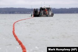 In this February 5, 2020, photo, nets are put into Smith Bay on Kentucky Lake near Golden Pond, Kentucky, during a roundup of Asian carp.
