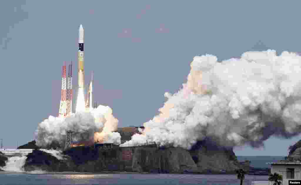 A H-IIA rocket carrying Hayabusa 2 space probe blasts off from the launching pad at Tanegashima Space Center on the Japanese southwestern island of Tanegashima, in this photo taken by Kyodo. The space probe sets off on a six-year round-trip journey to an asteroid for samples that scientists hope will help reveal the origins of life.