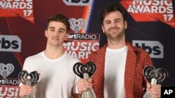 Drew Taggart, left, and Alex Pall, of the Chainsmokers, pose with the awards for best new artist, best new pop artist and dance song of the year for "Closer" in the press room at the iHeartRadio Music Awards at the Forum on March 5, 2017.