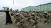 A priest blesses servicemen during a farewell ceremony at the Vaziani military base outside Tbilisi, Dec. 16, 2014. 