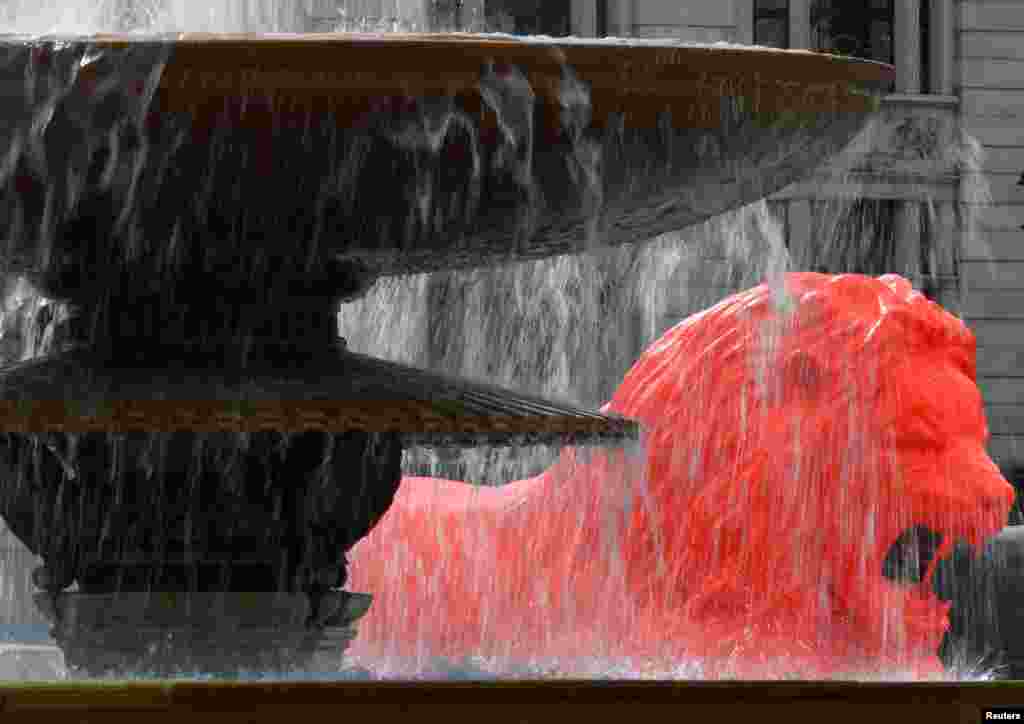 An orange painted lion, designed by artist Es Devlin, which forms part of the London Design Festival, is displayed in Trafalgar Square, London, Britain.