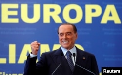 FILE - Forza Italia leader Silvio Berlusconi gestures during EPP European People's Party meeting in Fiuggi, Italy, Sept. 17, 2017.